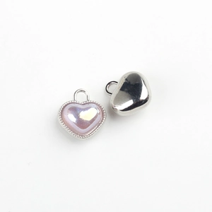 Detail of silver heart pendants with iridescent purple resin inlay and metal loops