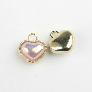 Macro view of heart-shaped resin charms with gold beaded edges showing front and back detail