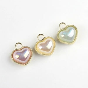Iridescent resin heart charms with gold-plated borders in pink, yellow, and green