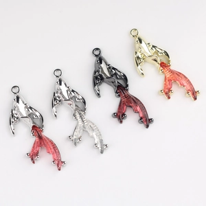 Detailed view of alloy goldfish pendants in gold and silver for DIY jewelry crafting