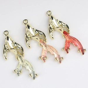Detailed view of alloy goldfish pendants in blue, pink, and red resin for DIY jewelry