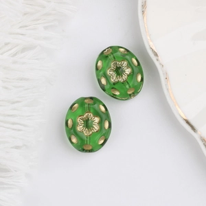 Detail of green Czech glass beads with gold garden floral patterns for DIY jewelry making