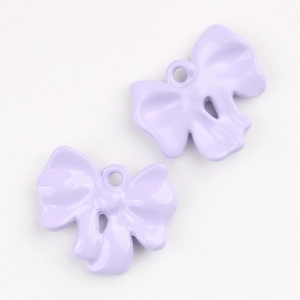 Close-up of two light purple alloy bow pendants with smooth finish for DIY jewelry making
