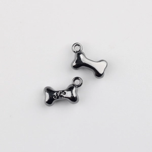 Macro shot of gun-black alloy bone charms with paw print texture for DIY jewelry making