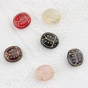 Handcrafted Czech glass ladybug beads with gold detailing for DIY jewelry making