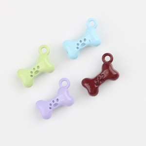 Set of four colorful bone-shaped alloy pendants with cutout paw prints and top metal rings