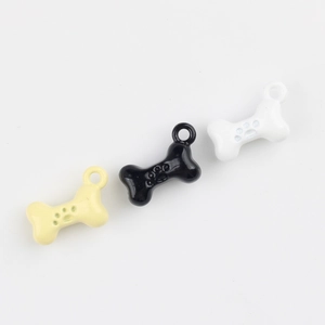 Macro shot of bone shaped alloy pendants with paw prints for DIY jewelry making