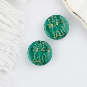 Detail of green Czech glass beads with gold cat pattern for DIY jewelry making
