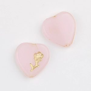 Detail of pink heart Czech glass beads with gold floral relief and foil for DIY jewelry