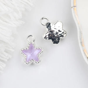 Detail of 11mm star charms in purple stone and hammered silver for DIY jewelry