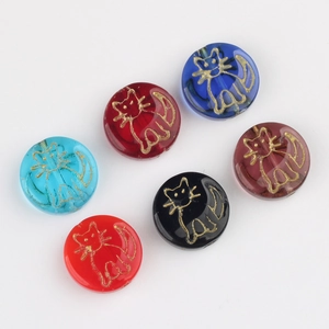 Detailed view of round Czech glass beads with gold cat engraving for jewelry making