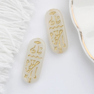 Detailed view of translucent Czech glass beads with gold Egyptian runes for DIY jewelry