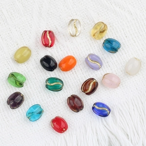 Handmade oval glass beads in various colors with golden coffee bean patterns