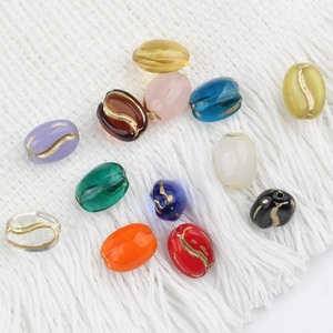 Macro shot of vintage colorful glass beads with gold swirl texture for jewelry making