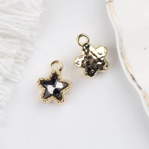 Detail of 11mm star pendant with black zircon inlay and hammered metal texture back