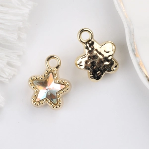 Detail of light gold star pendants with AB zircon inlay and hammered texture finish