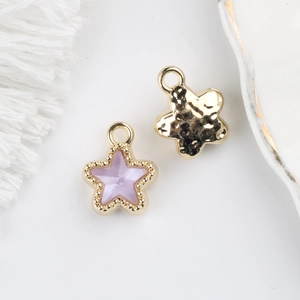 Detail of purple star pendant with gold trim and hammered texture on reverse side