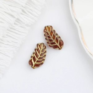Detail of 15x7mm amber glass leaf beads with gold veining for vintage jewelry making