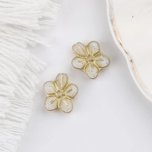 Detail of Czech glass five-petal flower beads with gold gilding for DIY jewelry making
