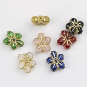 Detailed view of colorful flower-shaped Czech glass beads with gold-rimmed vintage finish