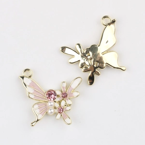 Detailed view of pink butterfly alloy pendant with cubic zirconia and faux pearl accents