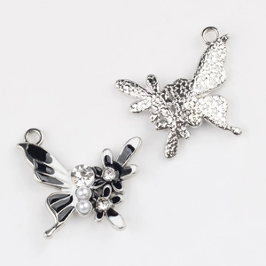 Front and back detail of butterfly charm with pearls, rhinestones and star pattern