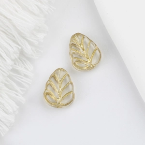 Macro view of two leaf-shaped glass beads with gold veins and vintage leaf vein detail