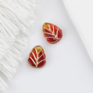 Detail view of red and gold leaf glass beads for vintage DIY jewelry making
