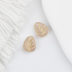 Macro detail of Czech glass leaf beads in soft pink with golden veins for DIY jewelry