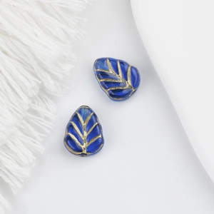 Detailed macro view of Czech glass leaf beads with gold veins for DIY jewelry making