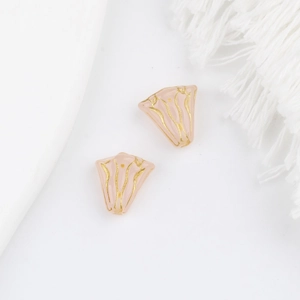 Detail van roze glas kralen in de vorm van blaadjes met gouden lijnen voor DIY sieraden