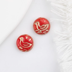 Detail shot of vintage red enamel bird beads with gold guilding for DIY jewelry making