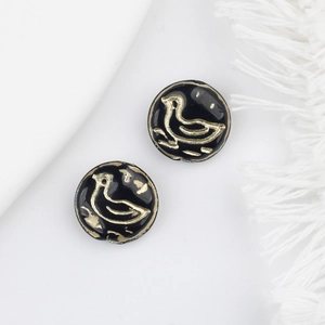 Detailed view of vintage black glass beads with golden bird patterns for DIY jewelry