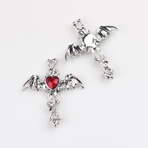 Gothic cross pendant featuring bat wings and a red heart zircon with silver plating