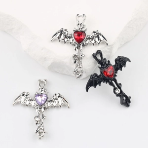 Gothic cross heart pendants with bat wings and zircons on white stone pedestals