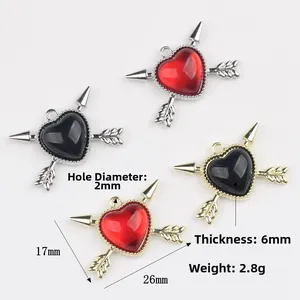 Arrow heart pendants in red and black resin with metal edges for jewelry making