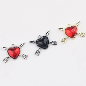 Arrow through heart pendants in red and black resin with beaded metallic borders
