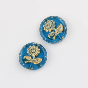 Macro shot of blue Czech glass beads with gold sunflower pattern and gold foil accents