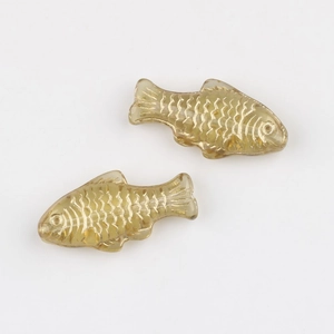 Macro shot of amber glass fish beads with gold detailing for DIY jewelry making