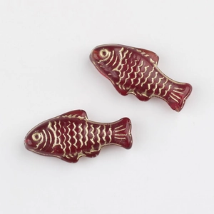 Detailed close-up of red Czech glass fish beads with hand-painted gold scales for DIY jewelry