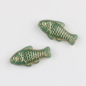 Detail of Czech glass fish beads in deep green with hand-painted gold scales for DIY