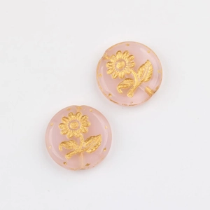 Detail of pink translucent Czech glass beads with gold painted sunflower patterns for DIY