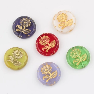 Flat lay of colorful Czech glass beads with gold sunflower patterns for DIY jewelry