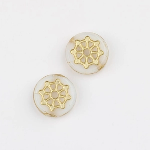 Detail of Czech glass beads with hand-painted gold spider web patterns for DIY crafts