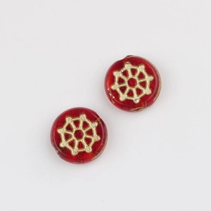 Detailed macro view of two red glass beads with golden geometric floral pattern for DIY jewelry