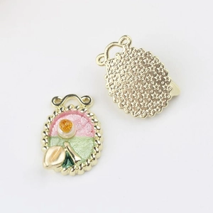 Detailed view of floral alloy pendant with pink enamel and pearl inlay for DIY jewelry