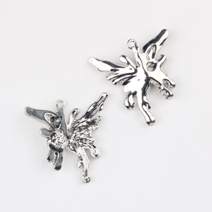 Macro detail of liquid metal butterfly charms with silver finish and black enamel drip