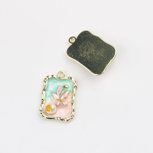 Detail of rectangular enamel charms with mint green pink inlay and pearl accents