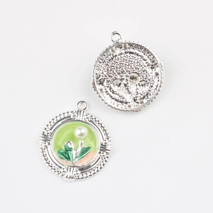 Detail of vintage round enamel pendant with faux pearls for DIY jewelry making