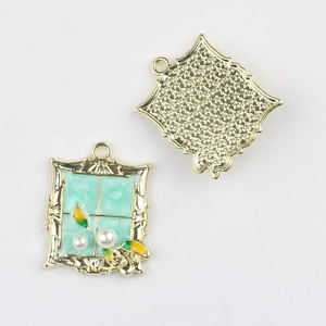 Detailed view of alloy window-frame pendant with green enamel and pearl inlay charms